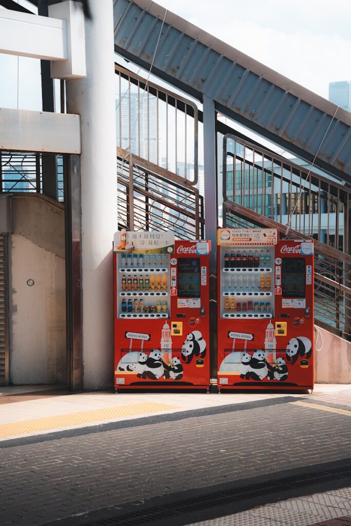 Two red vending machines with panda designs.